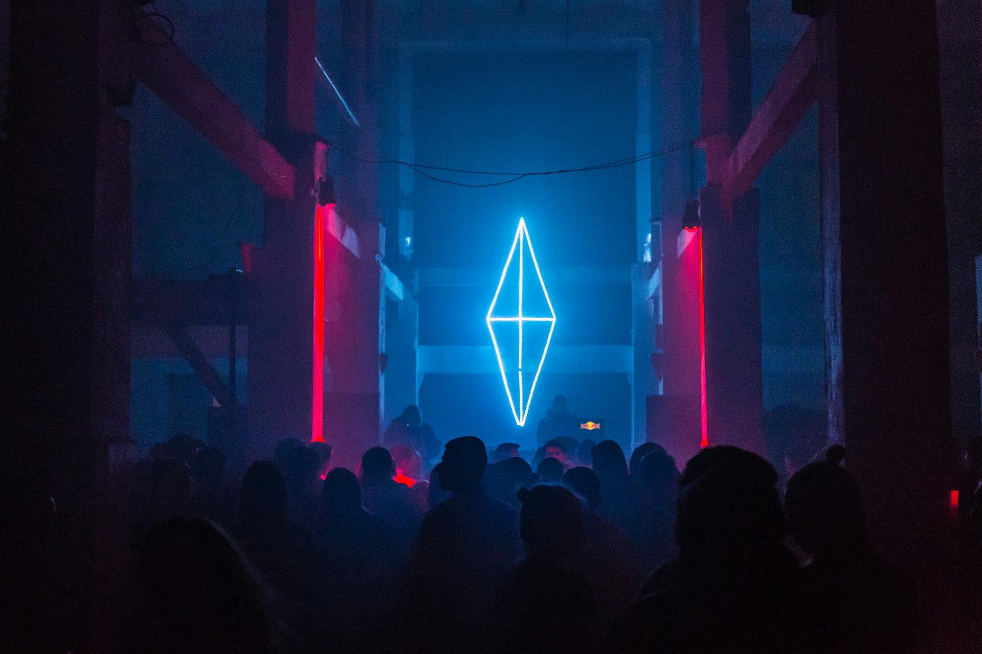 Digital art of crowd watching a glowing geometric shape
