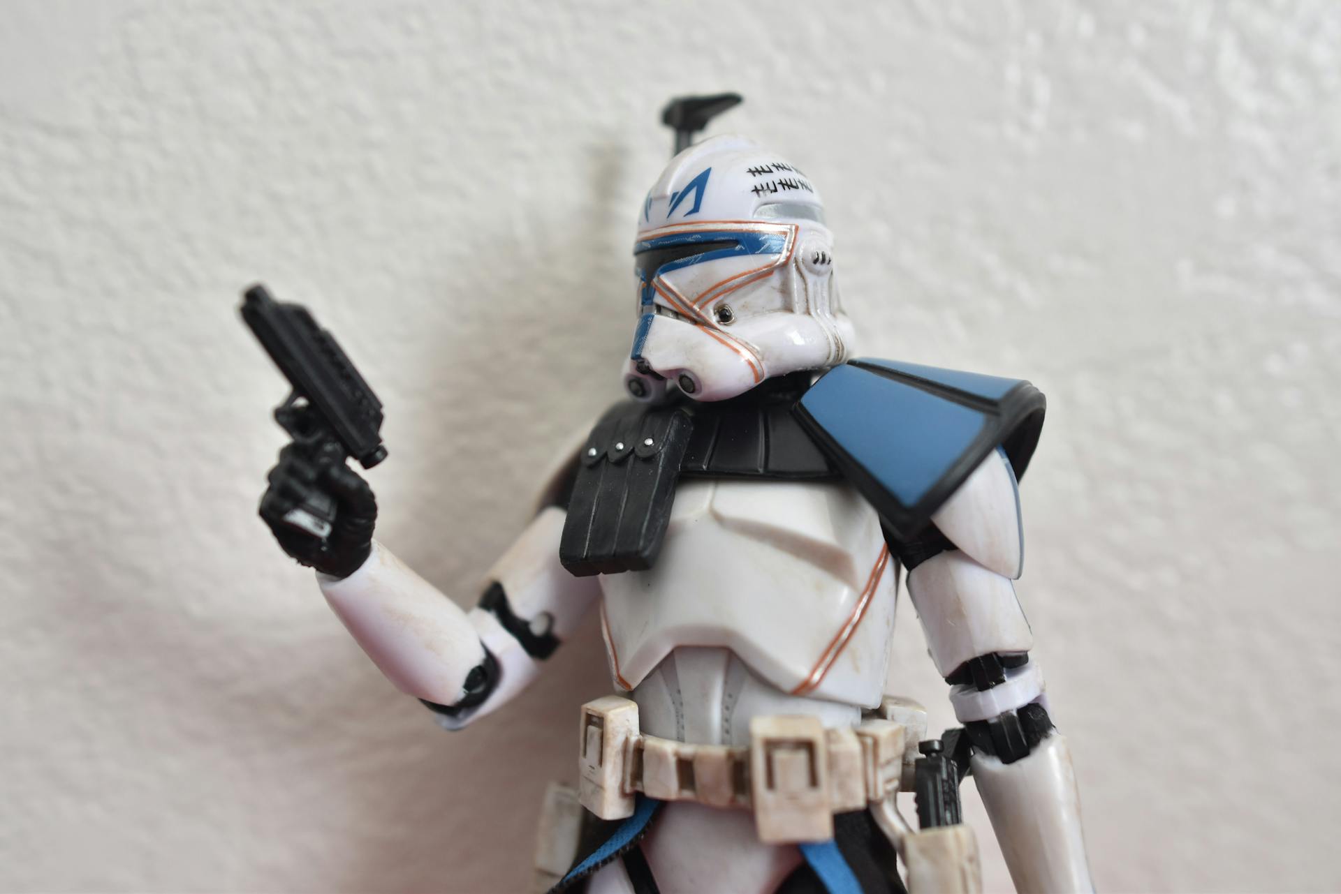 Close up of a storm trooper figurine with blue shoulder detail