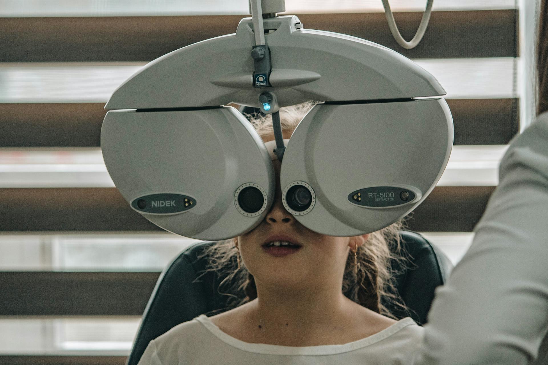 Young girl at the doctors office doing an eye test